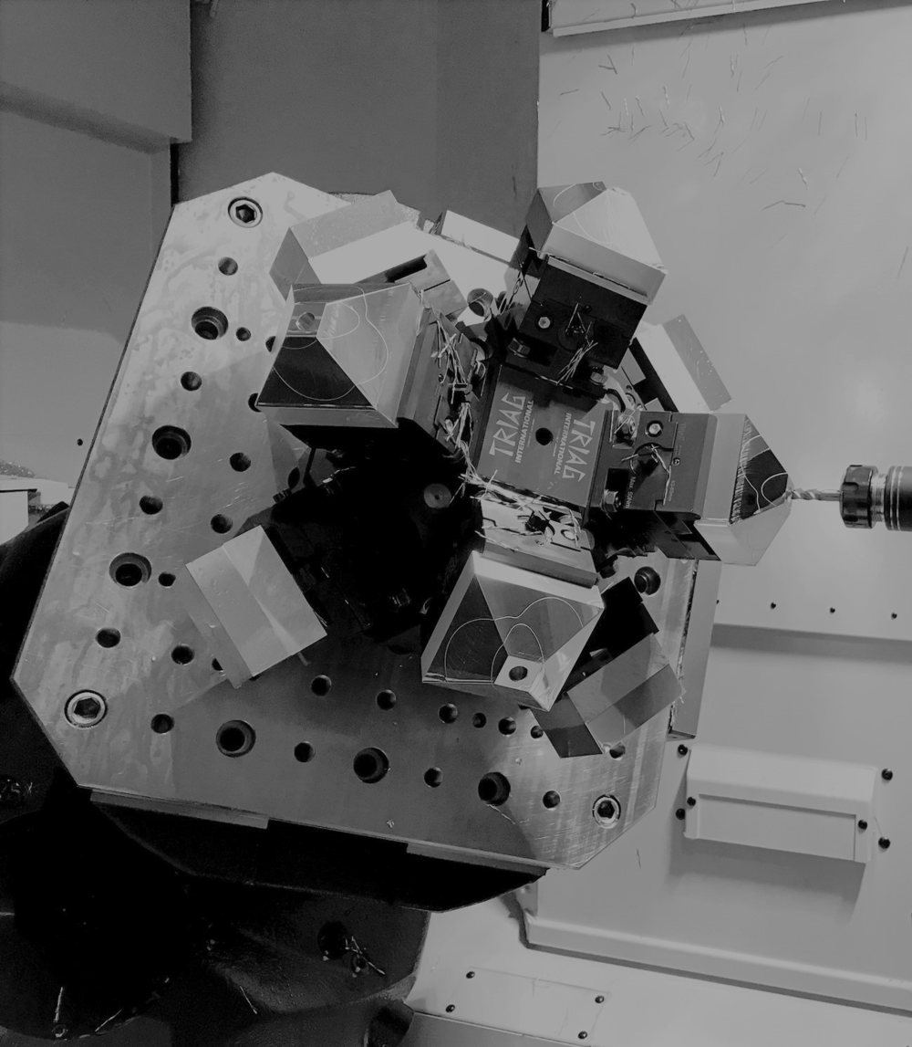 Multi-part fixture with machined parts on a machine pallet