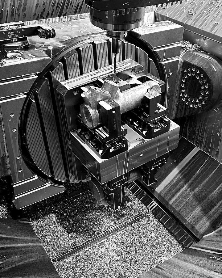 Automotive part clamped on a 5-axis trunnion table