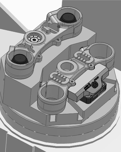 CAD model of two motorcycle triple clamps on a machining fixture